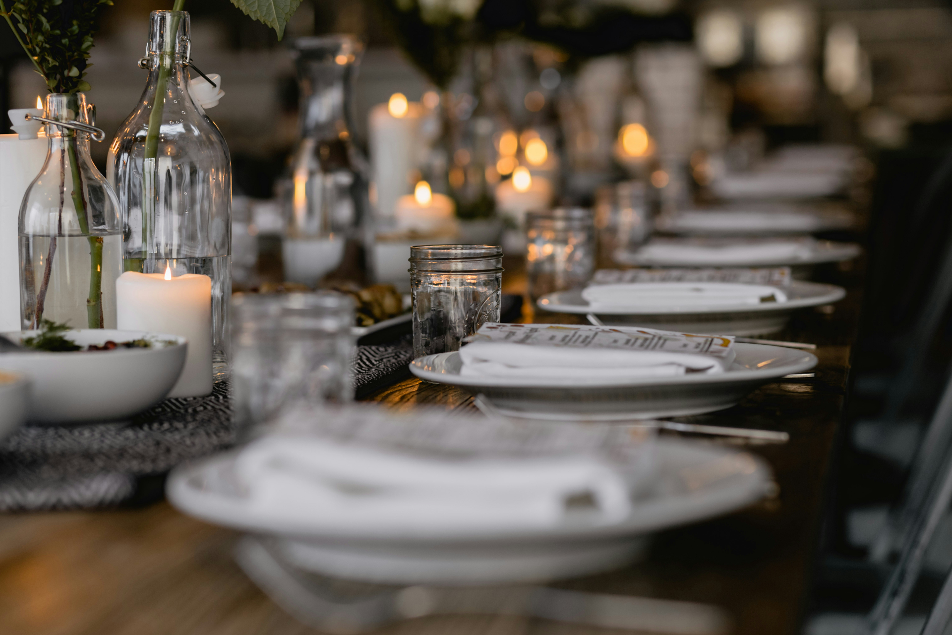 A candlelit private dining table set for a small group in an elegant New York restaurant